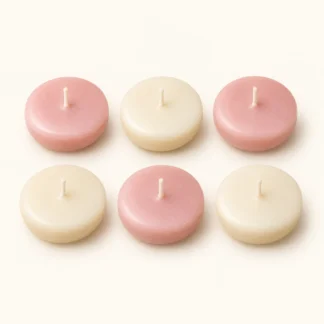 Six unlit round floating candles in two rows