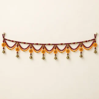 Horizontal beaded door toran with marigold motifs and small brass bells
